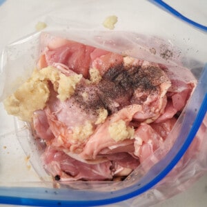Chicken and marinating ingredients in a bag