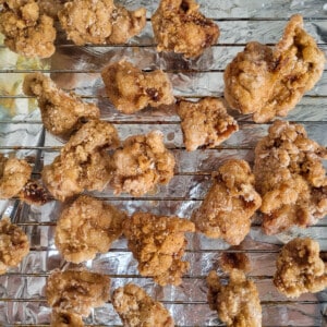 Fried chicken draining on a wire rack
