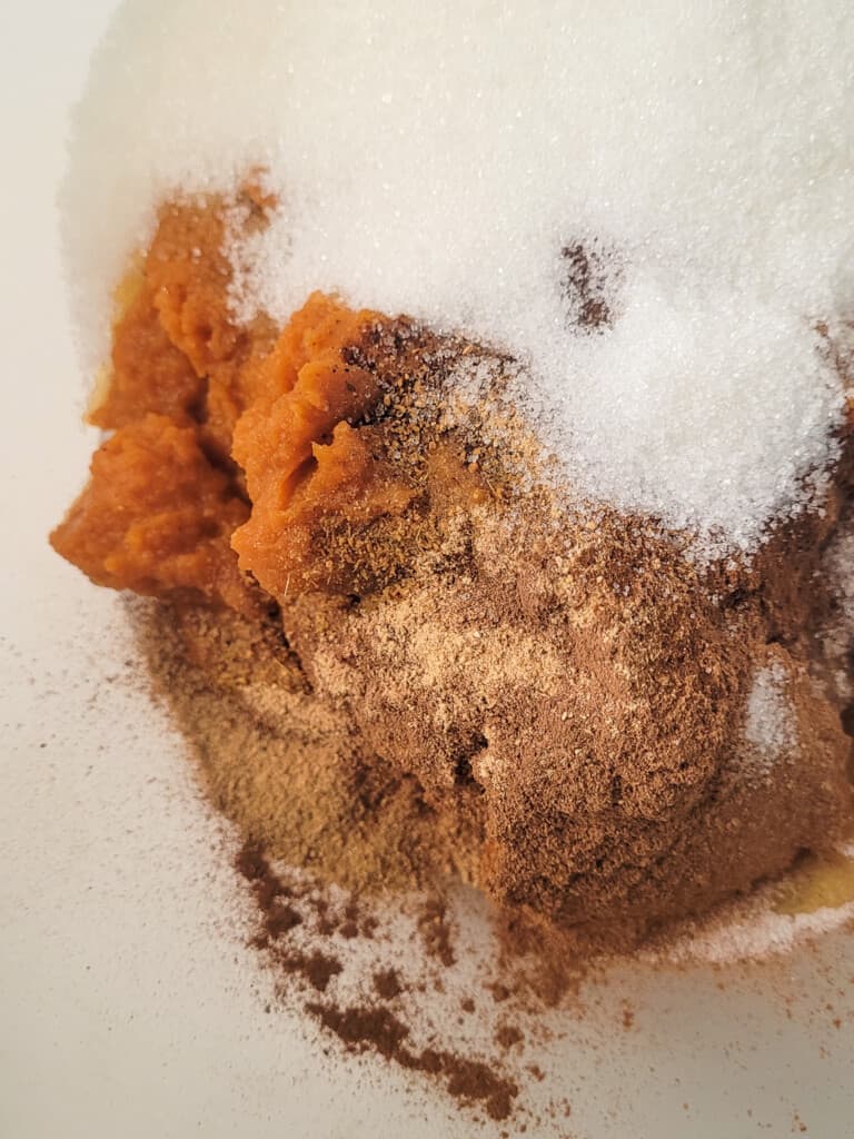 Baking spices, pumpkin puree, and sugar in a bowl