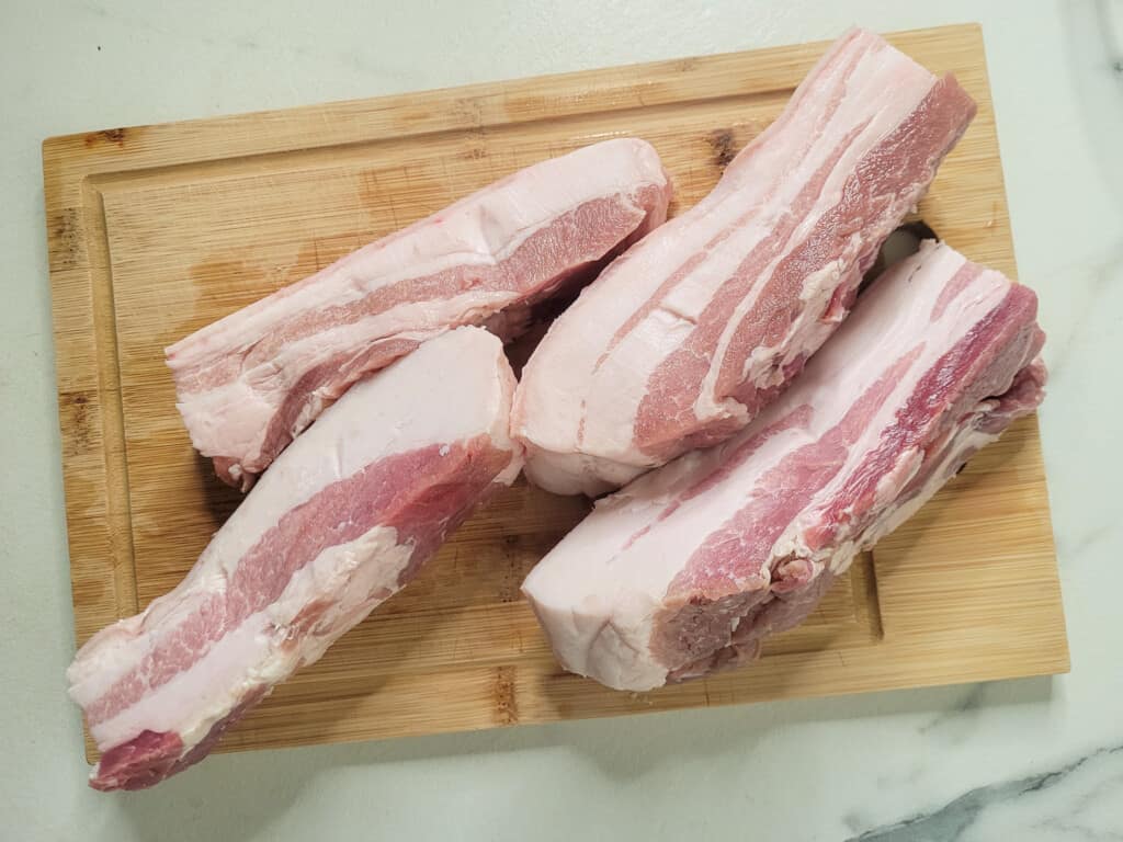 Sliced pork belly on a cutting board