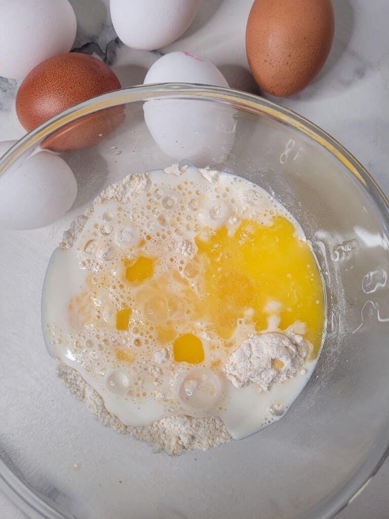 Wet ingredients mixed with dry ingredients in a bowl