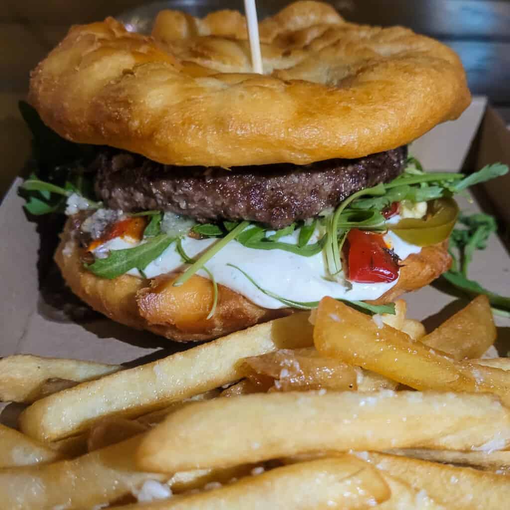 Langos burger, a popular food in Budapst, with some fries