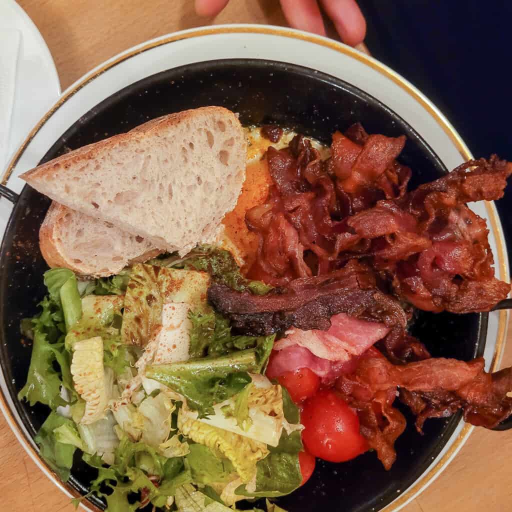 Plate of pesto and eggs with bacon