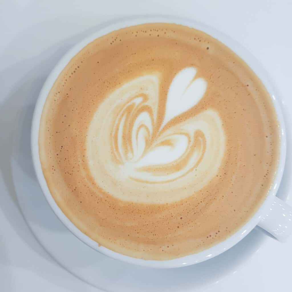 Espresso with milk on a white table in a Budapest Cafe