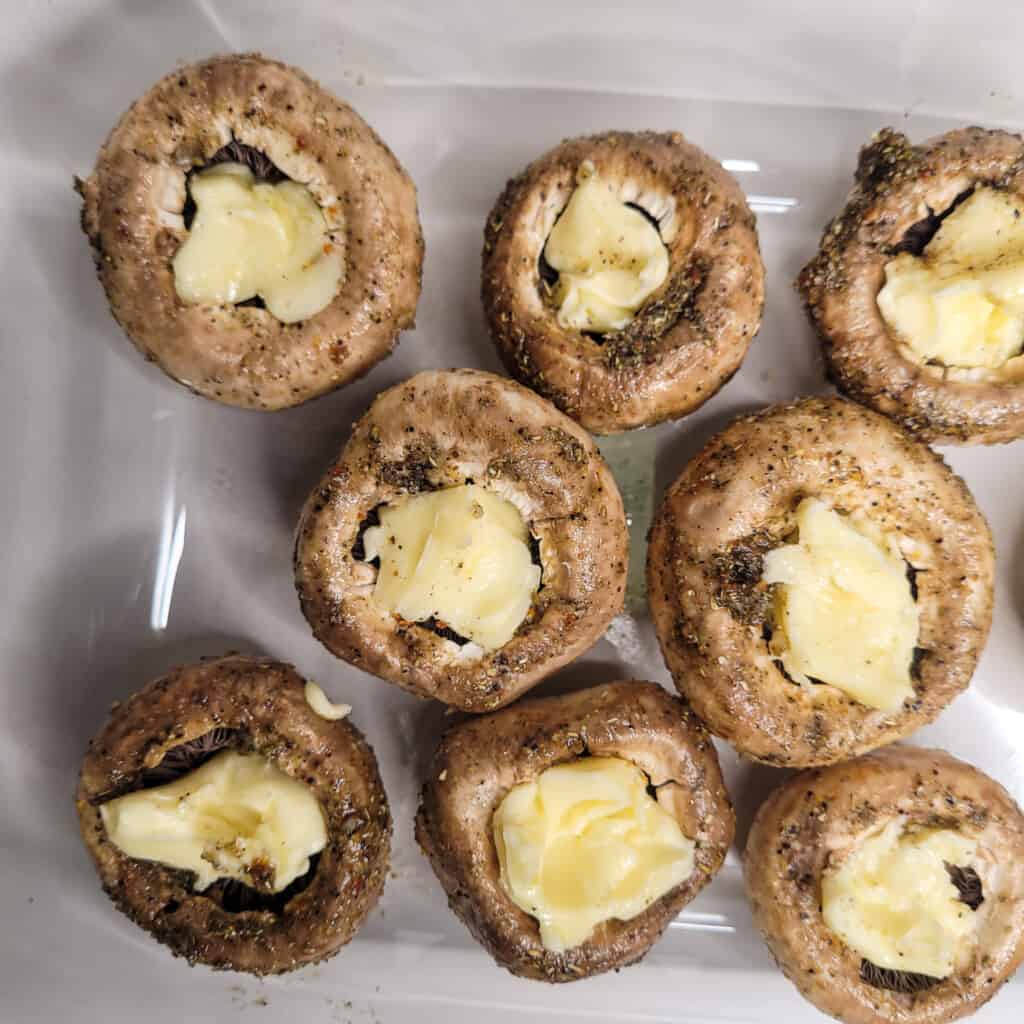 Mushrooms stuffed with butter in a pan