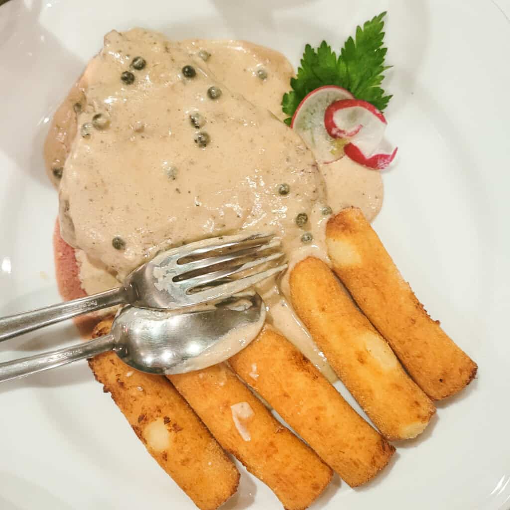 Chicken Fillet next to crispy croquettes