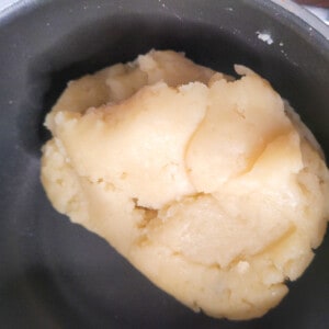 Cooked churro dough in a pot