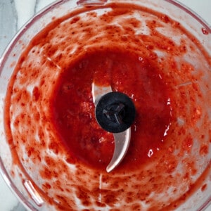 Pulverized strawberries inside a food processor.