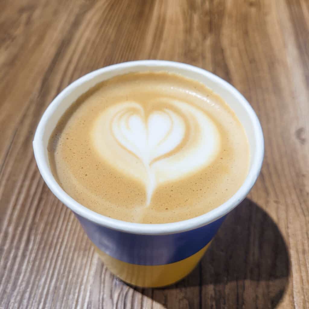 A latte paper cup designed like the flag of Ukraine