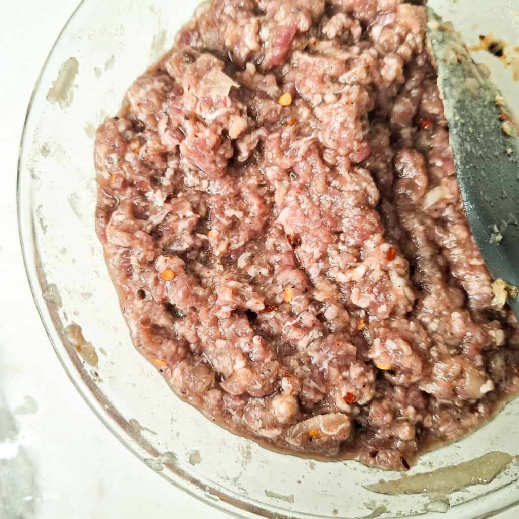 Bowl of minced meat with water added to it.