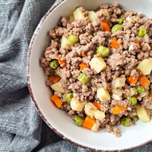 Closeup of ground meat with vegetables in a white bowl