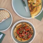 Multiple blue plates of food on a wooden table