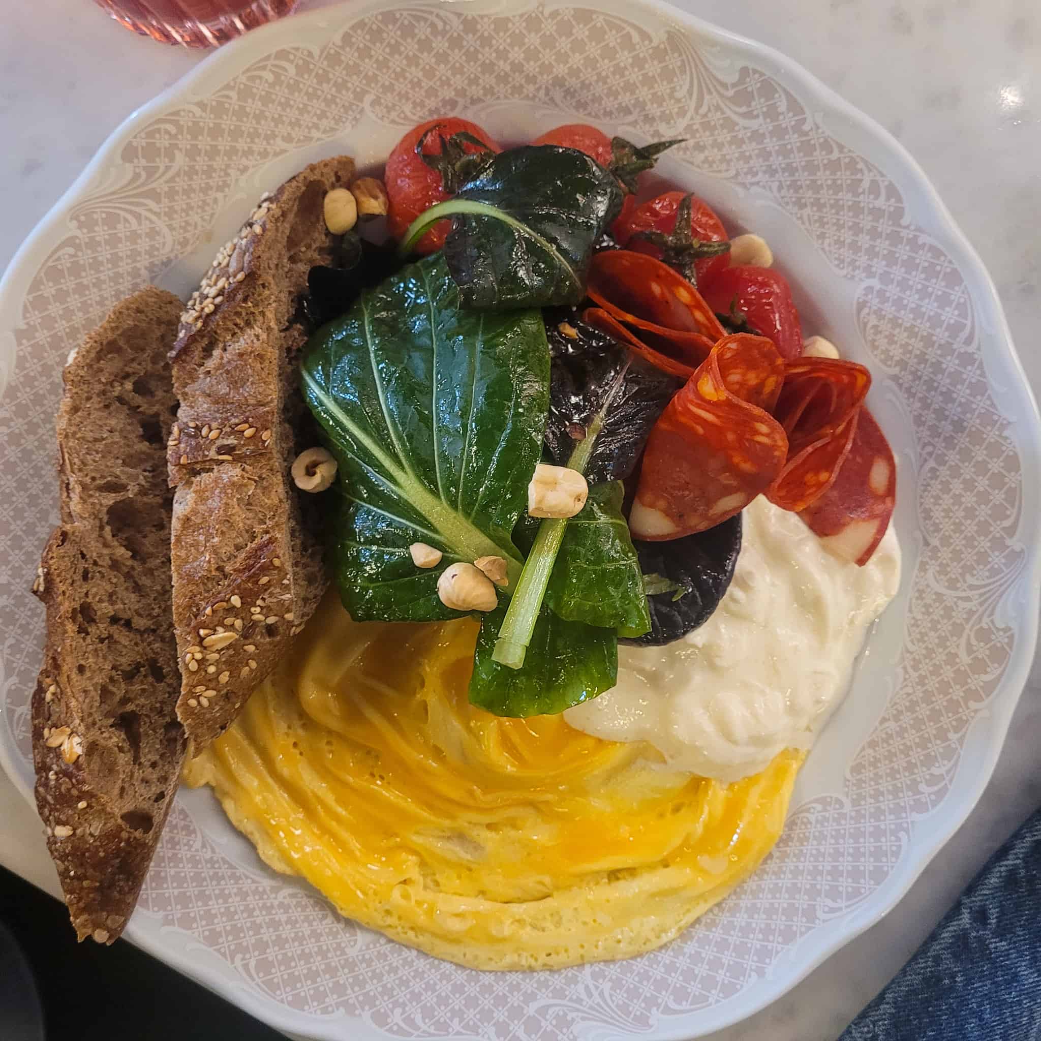 A closeup of a bowl of eggs with slices of chorizo one of the best breakfast in Tbilisi