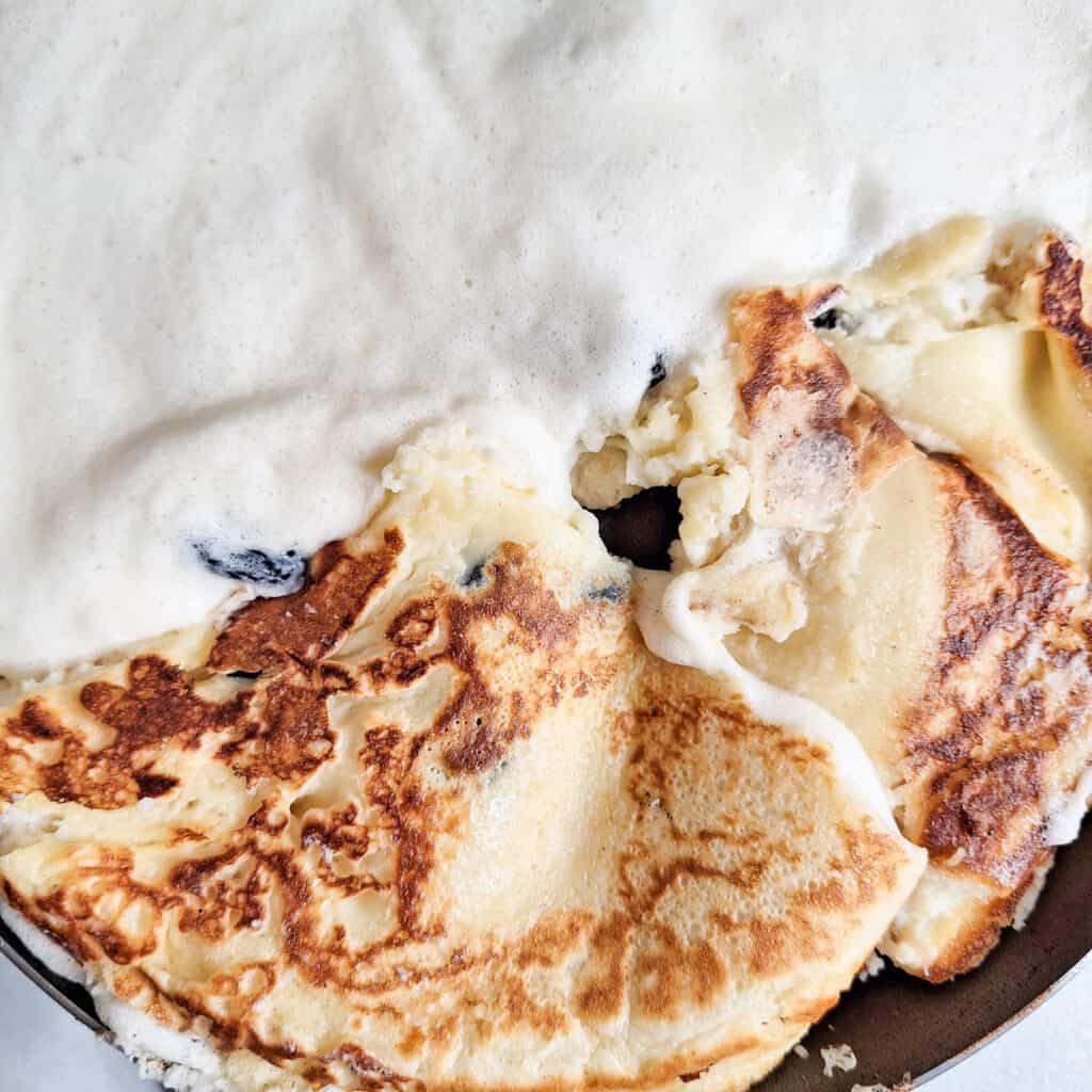 Flip over Austrian Kaiserschmarrn or torn pancakes in sections
