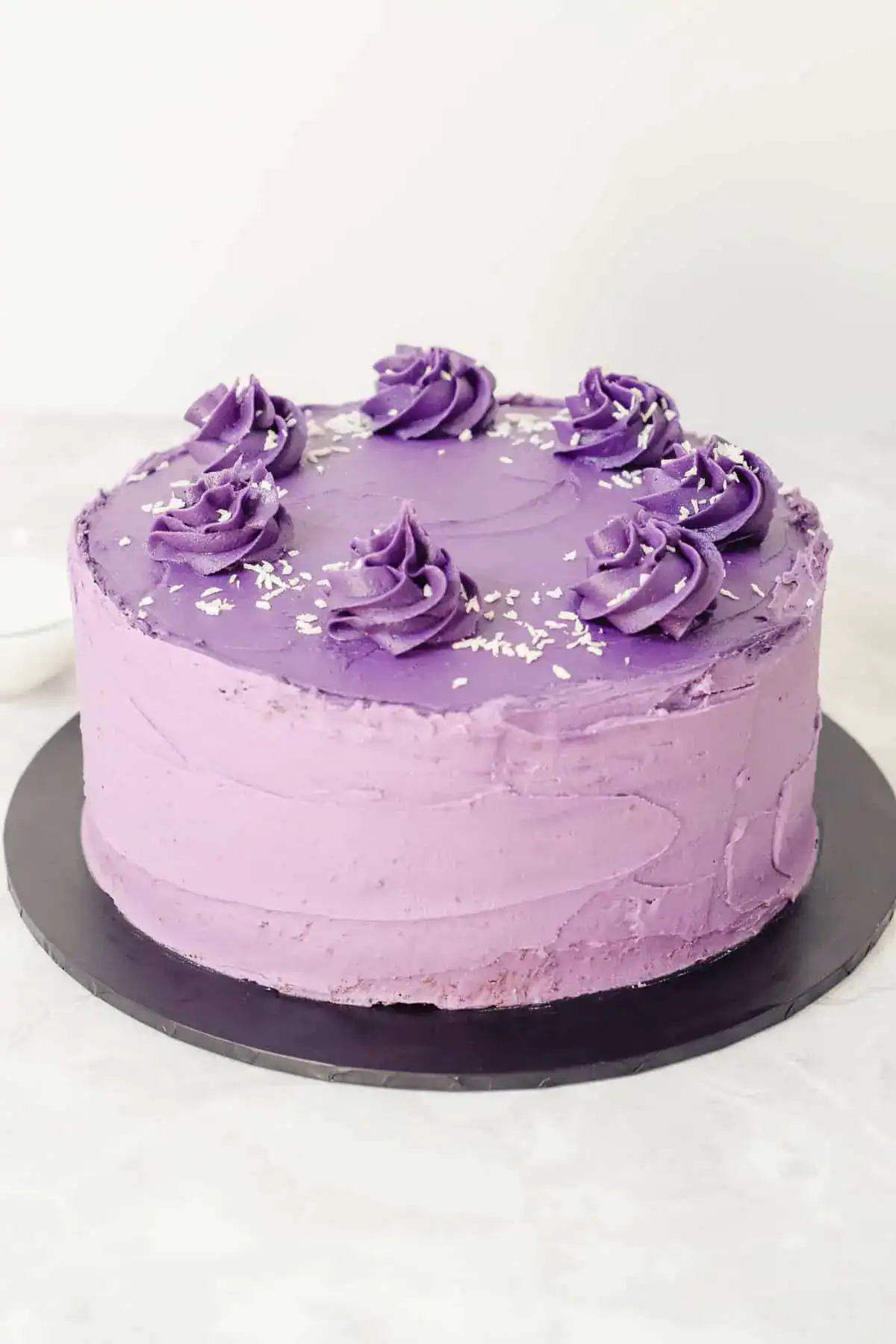 Ube cake or purple yam cake on a dark gray plate