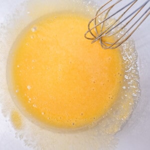 Mixed egg yolks, sugar, and cornstarch in a glass bowl