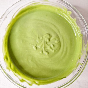 Matcha custard inside a glass bowl