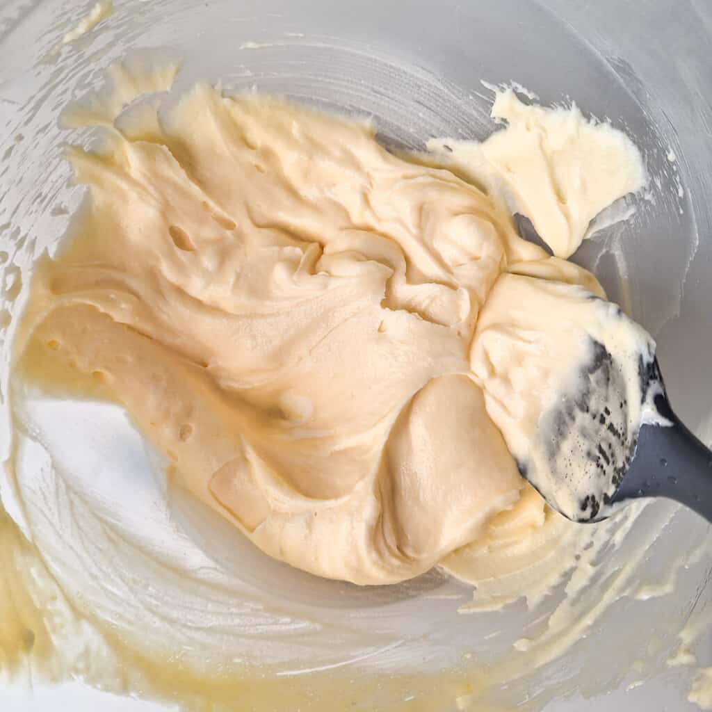 Fold the mascarpone cheese and tiramisu egg mix in a glass bowl