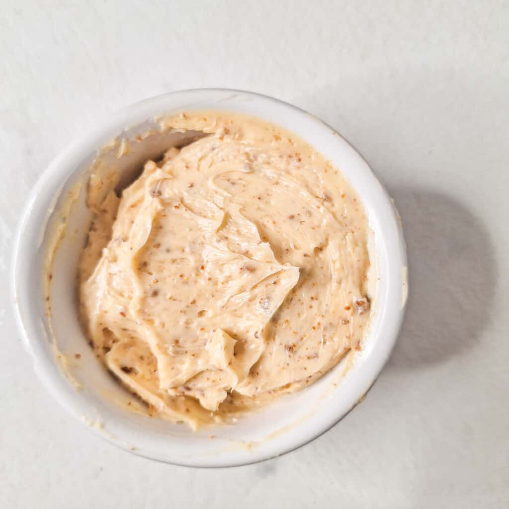 Adjika butter in a small white bowl