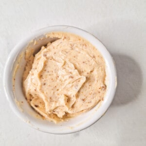 Adjika butter in a small white bowl