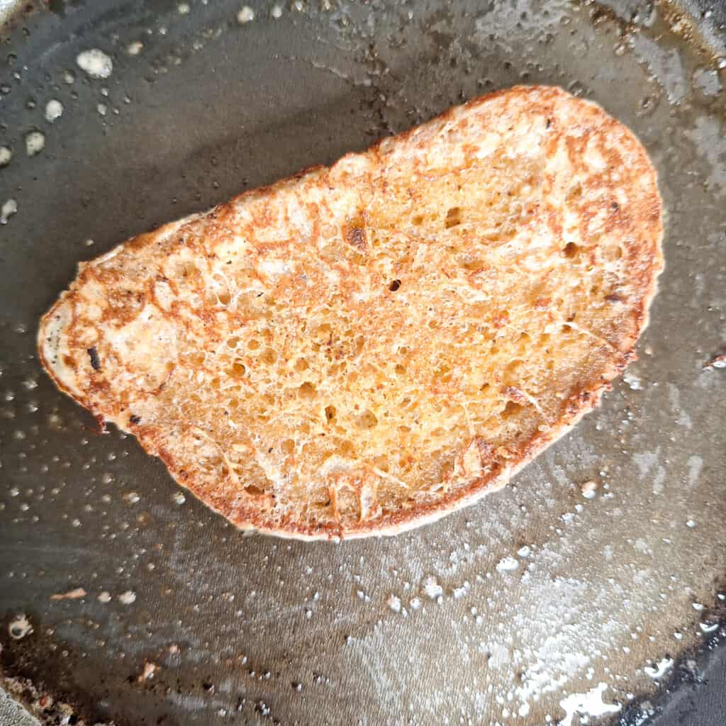 Fried Georgian egg bread or kikliko on a buttered pan