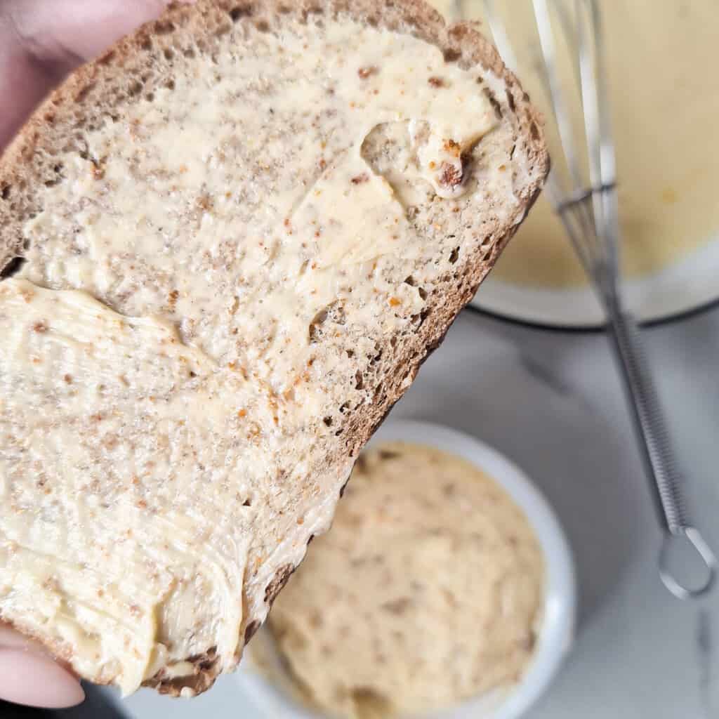 Closeup of sliced bread with seasoned butter spread across