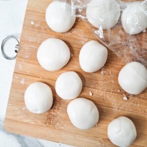 Small pieces of raw glutinous rice flour dough on a wood surface
