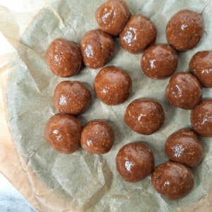 Caramel shaped like small balls on a plate lined with wax paper