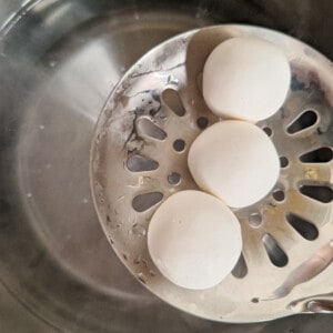 Pieces of raw tang yuan over a pot of water