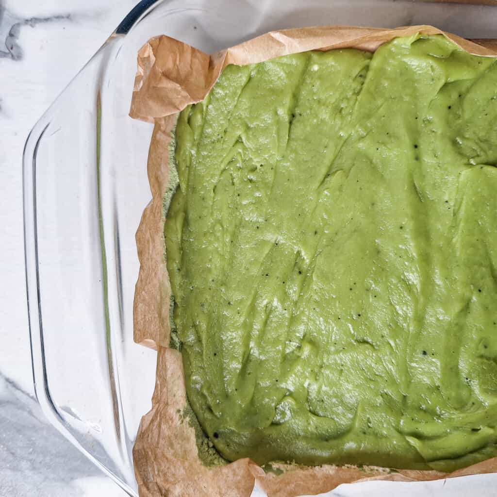 Chewy matcha rice cake spread across glass container