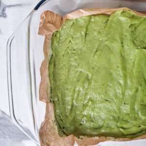 Chewy matcha rice cake spread across glass container