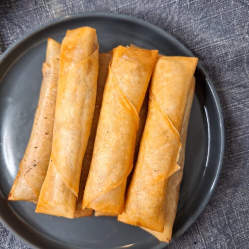 Lumpia shanghai stacked on a plate