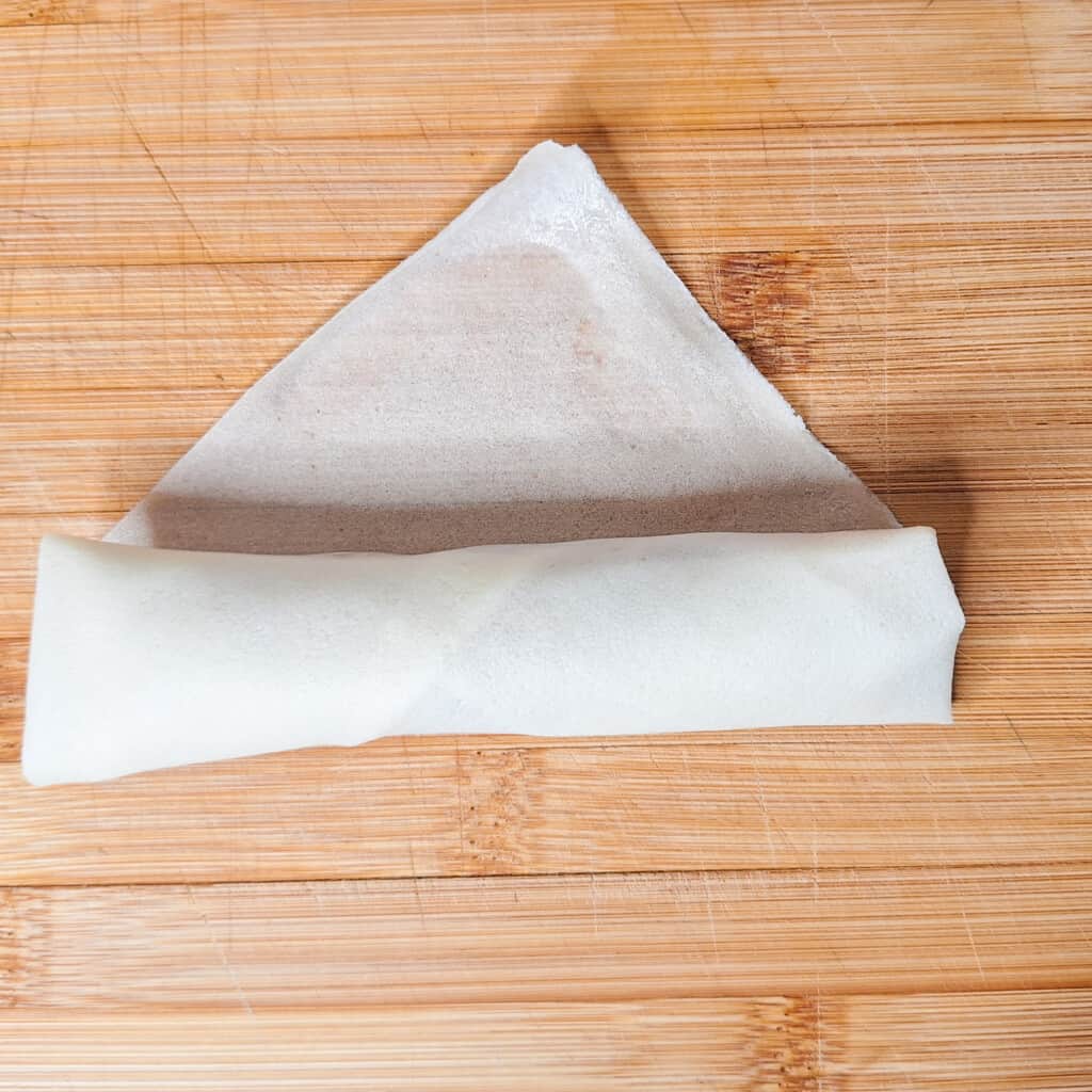 Filipino spring roll or lumpia in process of rolling