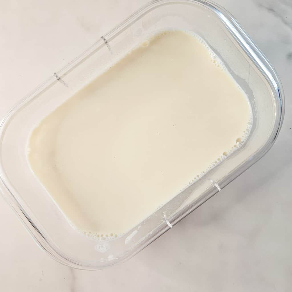 Thicken soy milk in a container for taho