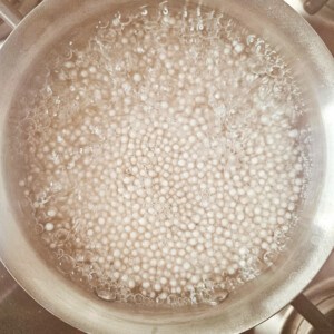 Tapioca balls in boiling hot water in a stainless steel pot