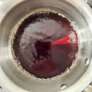 Boiling water and brown sugar syrup in a stainless steel pot for taho
