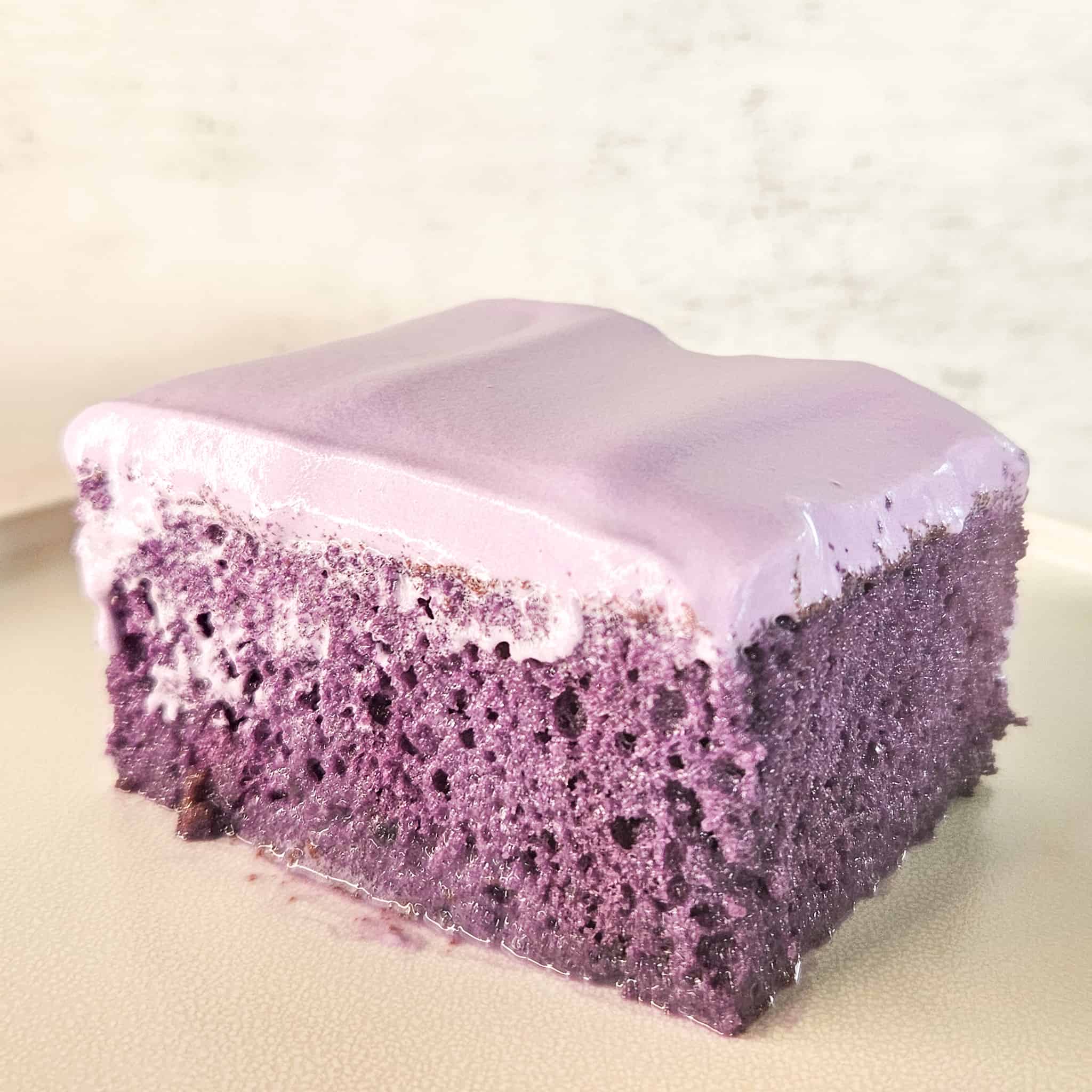 Ube tres leaches cake on a plate