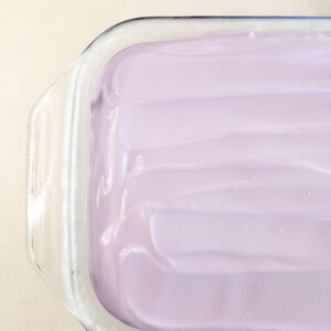 Ube whipped cream in a glass baking dish
