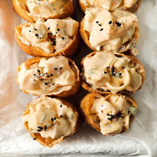 Close up of shrimp inari sushi with black sesame seeds
