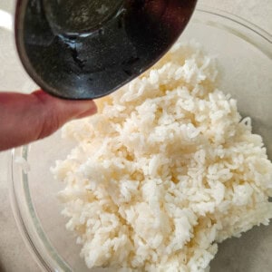 White rice in a bowl with vinegar and sugar mixture