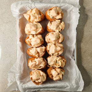 Twelve pieces of stuffed tofu pockets with shrimp and Kewpie mayo on a lined baking sheet