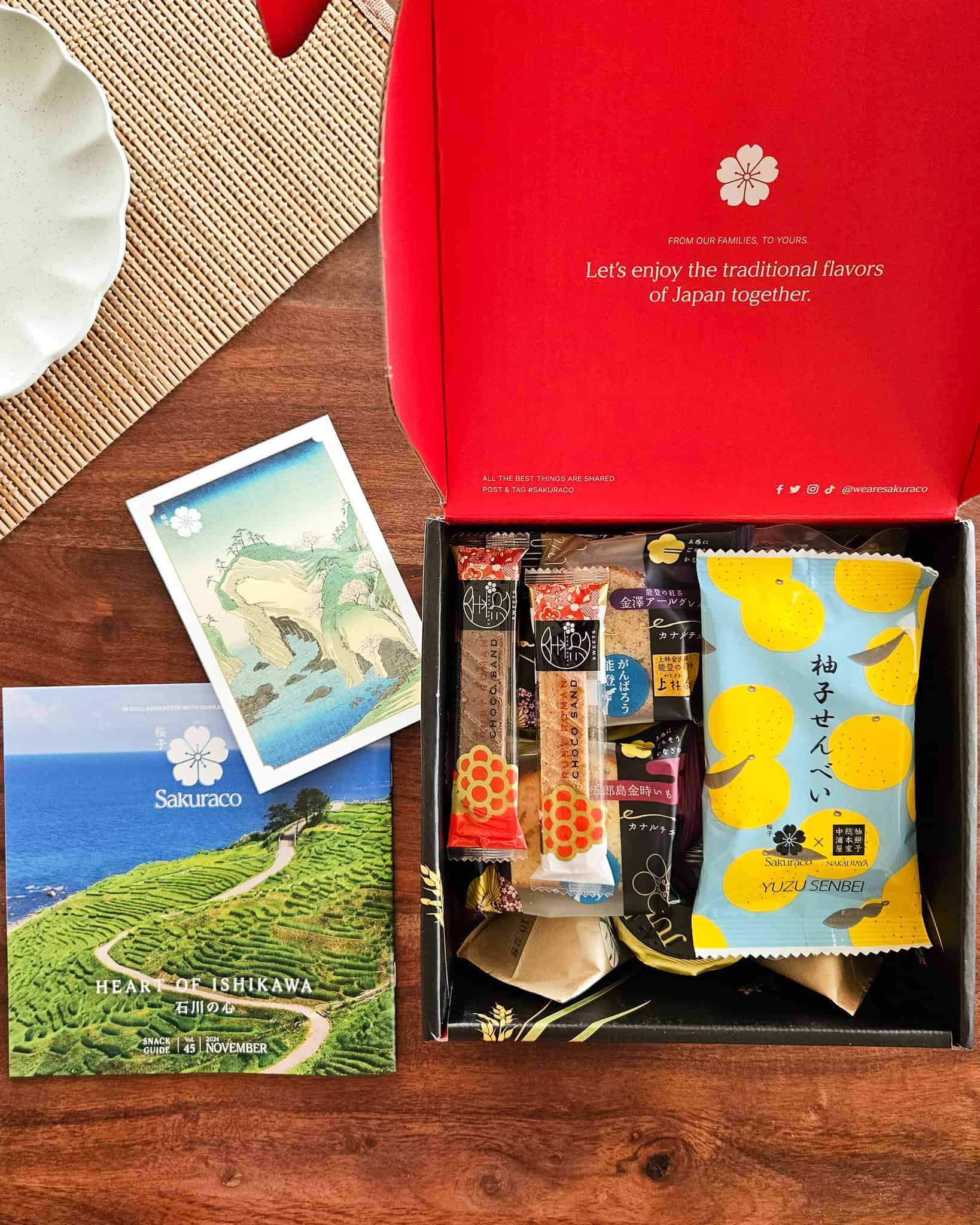 Opened Sakuraco snack box with booklet and postcard