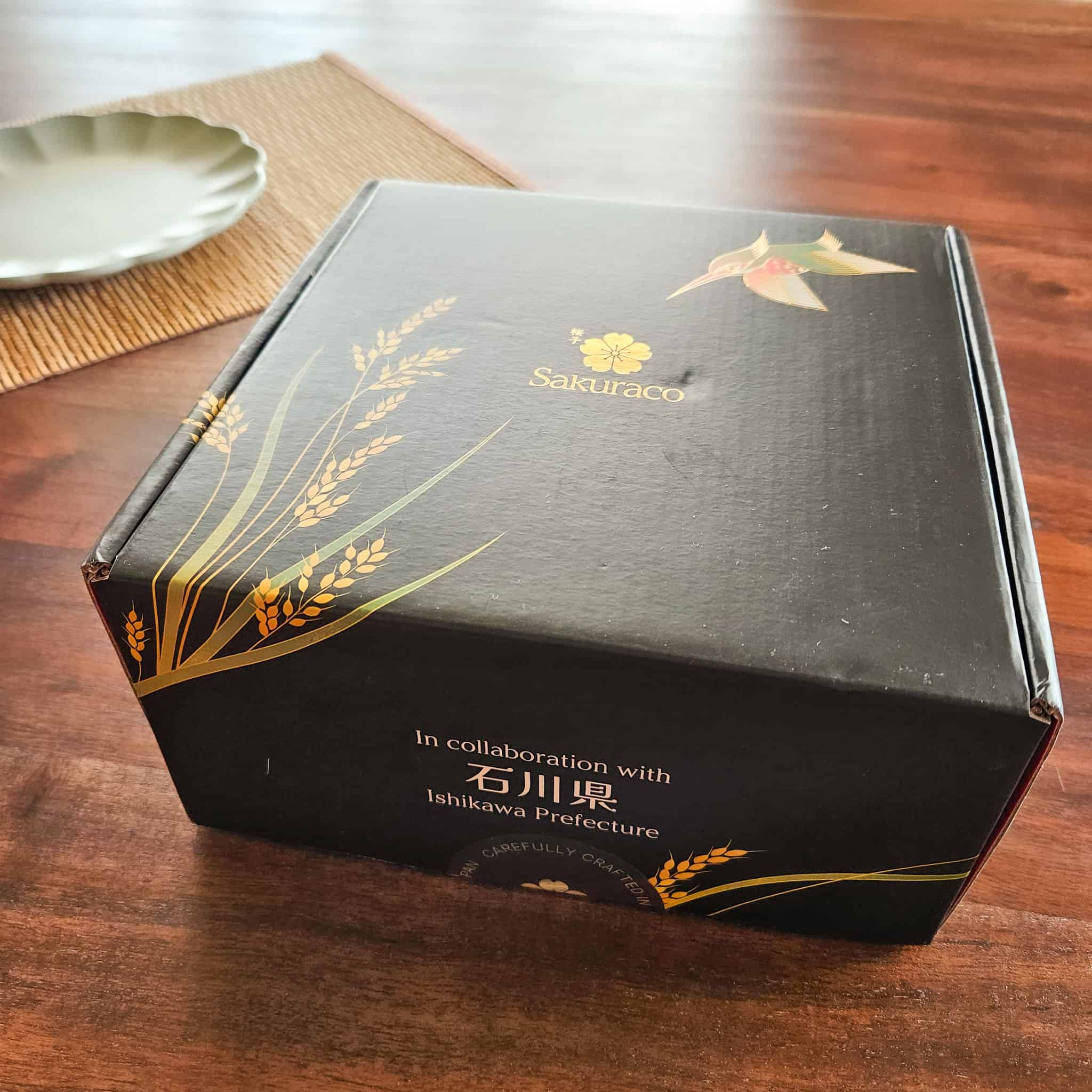 Unopened Sakuraco Japanese subscription box on a wood table