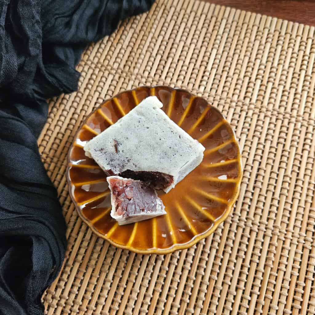 A sliced piece of kintsube, or coated red bean paste