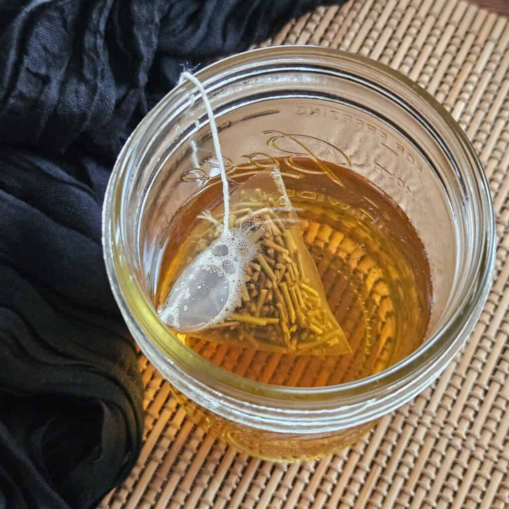 A mason jar with matcha stems tea